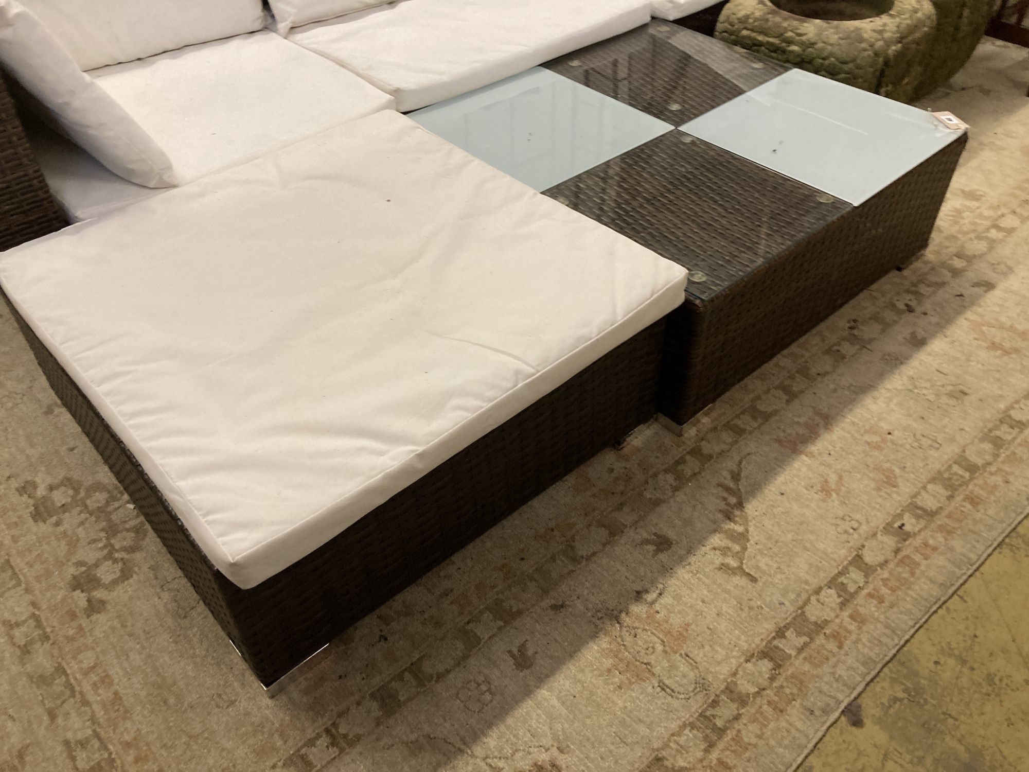 A rattan garden sofa, foot stool and glass top table, sofa width 210cm depth 70cm height 54cm